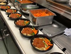 Line of meals being prepared for delivery