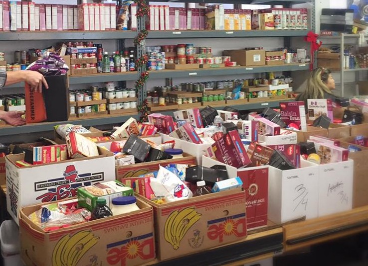 community food pantry with shelves and boxes of food