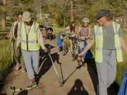 Volunteers picking up trash around the bike path. 