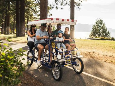Tahoe Bike Company Surrey with four pedaling adults and young kid upfront