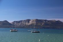 boats on lake tahoe with sierra range in background