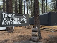 Black Semi Tractor Trailer with Tahoe Outdoor Adventures Banner Out Front