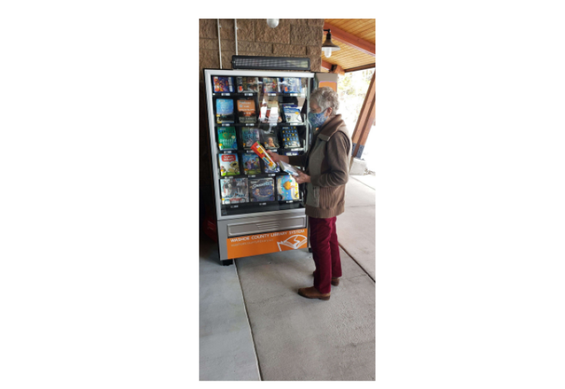 Woman using Washoe County Library Book Machine 